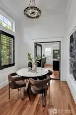 Sky high ceilings in this cozy breakfast nook with custom built-in shelf and high-end designer lighting!