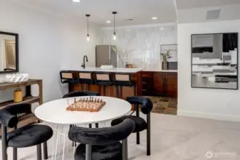 An entertainer’s dream, this exquisite full bar is the heart of the lower level! Stunning light and bright quartzite counters create a striking focal point, while curated tiling adds a touch refinement.