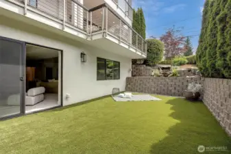 Seamlessly extending from the lower level, this private turf area offers a tranquil escape with effortless maintenance!