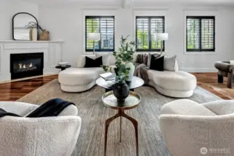 Expansive Great Room features a gas burning fireplace, walls of windows and French Doors leading to a private deck.