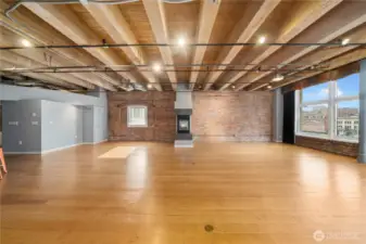Open beamed ceiling with sufficient lighting for office or home. Three ceiling fans as well.