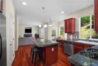 View from Kitchen entry looking through to Family Room. Lots of windows with tons of natural light to show off those gleaming cherry hardwood floors!