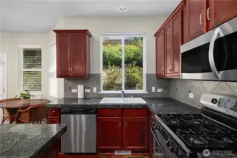 Spacious Kitchen with cherry cabinets and granite counters.