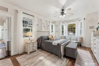 Primary bedroom with new lvp flooring, walk in lcoset with built in