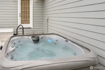 New hot tub off primary suite with new concrete and privacy fencing