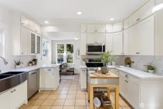 The spacious eat-in kitchen has been recently remodeled and features crushed quartz countertops and white shaker style cabinets.