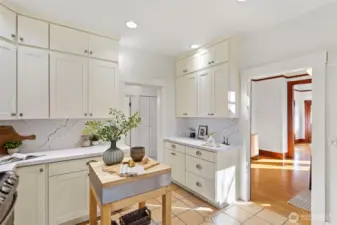 The kitchen has room for a mobile island and features an extra wall of cabinets with workspace.  So much storage!