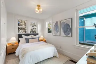 Bedroom #3 on the main floor features 3 windows (one overlooking the lovely backyard), a new glass light fixture and new carpeting and paint.