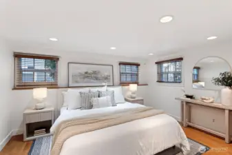 Lower level primary suite fits a king sized bed shown here.  This light and bright room has newer windows and custom blinds.