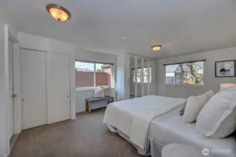 A serene downstairs retreat! This spacious bedroom features plush new carpeting, neutral tones, and a private door leading directly to the backyard. Perfect for enjoying a quiet breeze or easy access to the outdoor living space.