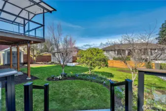 Step out onto the expansive lower deck to take in the year-around color of hundreds bulbs and beautiful flowering trees.