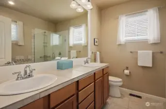 Spacious Primary bathroom with double sinks and ceramic tile floors. There are two windows in your bathroom, plenty of light!