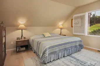 Spacious second bedroom, maple floors continue, and with a view of the 18th fairway.