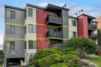 Spanning the SE corner, with deck overlooking a tree lined street.