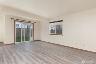 Living room leads to backyard.