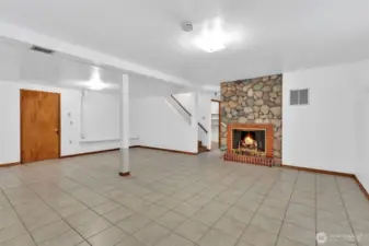 Rec room with woodburning fireplace.