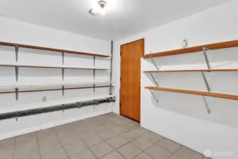 Storage room with shelving to keep you organized. Door leads to backyard and storage area under the deck.