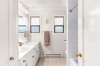 Bright and sunny main bathroom with tub and shower.