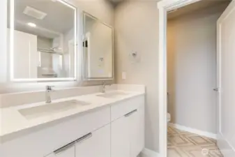 Primary ensuite with double sink and private lav.
