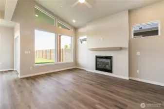 Living area has a gas fireplace and glass slider leading to backyard