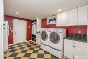 Utility room with door to lower covered deck and hot tub area.