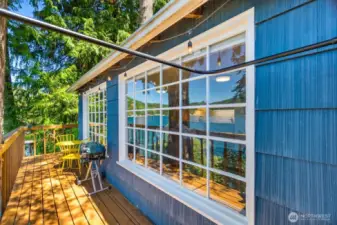 Exterior cabin view of large windows as seen from outdoor shower.