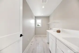 Upstairs laundry room. Previous built Peak house. Finishes may be different.