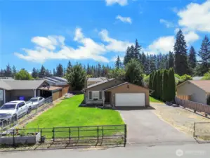 Completely fenced yard with driveway gate.