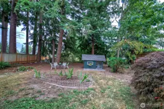 One of the garden areas and play house