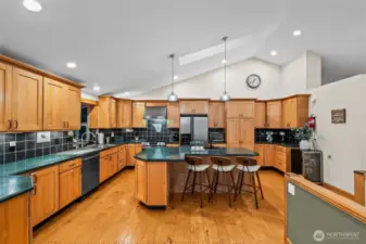 Entertainers Kitchen features stainless steele appliances a coffee nook and wine fridge.