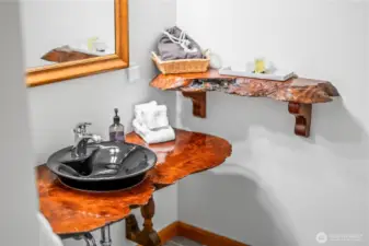 Locally sourced millwork featured throughout the house including this live edge counter and shelving in the 2nd floor bathroom.