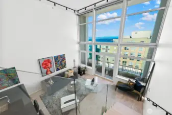 A glass-panel stair railing offers breathtaking views of the Puget Sound