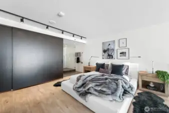 Upstairs, discover the expansive primary bedroom, complete with an ensuite bathroom and a walk-in closet, both offering sliding doors for enhanced privacy