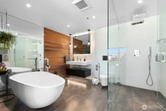 Premium Porcelanosa Upgrades: Heated floors, glass-enclosed showers, waterfall shower head, a freestanding soaking tub, heated towel rails, and designer tiles, fixtures, and cabinetry
