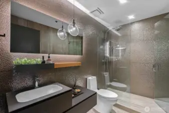 Premium Porcelanosa Upgrades: glass-enclosed shower, contemporary shower head, and designer tiles, fixtures, and cabinetry