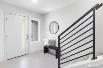 Covered entry on ground level opens to bright foyer with durable tiled floor.