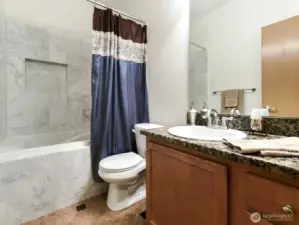2nd Bath in hall. Jacuzzi tub. Tile enclosure. Granite counter tops backsplashes. Tile Flooring.