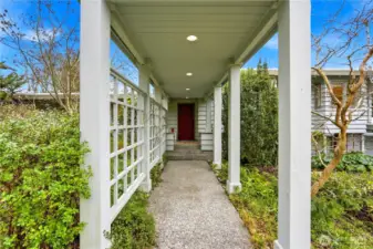 The covered portico provides a welcoming, sheltered entry.