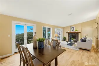 The dining area opens to the cozy living room, complete with a fireplace. Multiple french doors provide easy access to the outdoors.