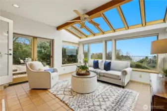 French doors in the sunroom open directly onto the large deck and patio beyond.