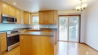 View from living room looking towards adjacent dining room and kitchen.