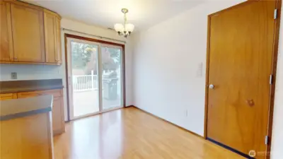 A dining room with convenient slider to access the massive back deck for seemless entertaining.