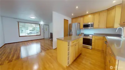 View from dining room looking towards adjacent kitchen and living room.