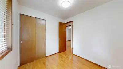 First of three bedrooms looking back to the hallway