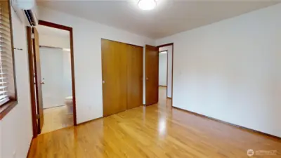 The primary bedroom, showing the door to the 3/4 bath ensuite and door to hallway.