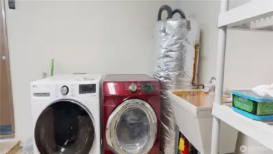 The washer and dryer have dedicated space in the 1-car garage with convenient utility sink.