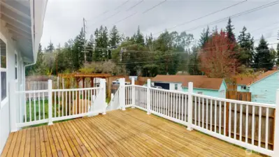Entertainment deck overlooks the back yard with access to the dining room and kitchen.
