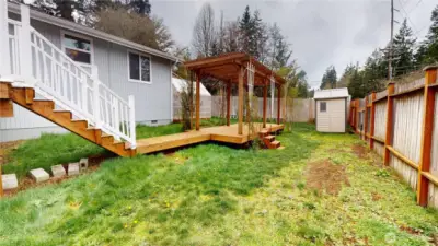 The backyard is an entertainers delight with stairs on one side of the deck leading to the enormous pergola.
