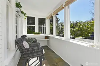 Sun room porch provides pleasant entry and all-season relaxation.