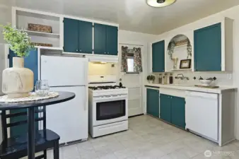 Cute eat-in kitchen with gas stove.